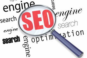 A magnifying glass hovering over several words - search, engine, optimization, focusing on acronym SEO